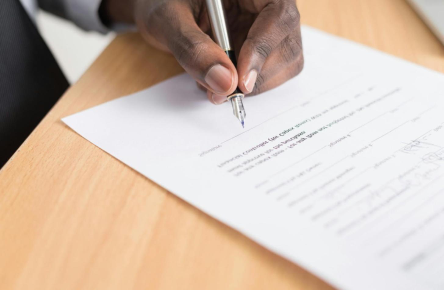 Real estate professional reviewing market data and property analysis documents